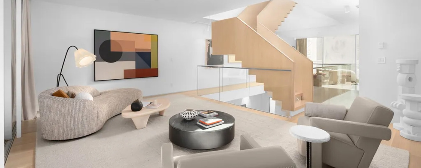 Modern living room with stairs and silver coffee table