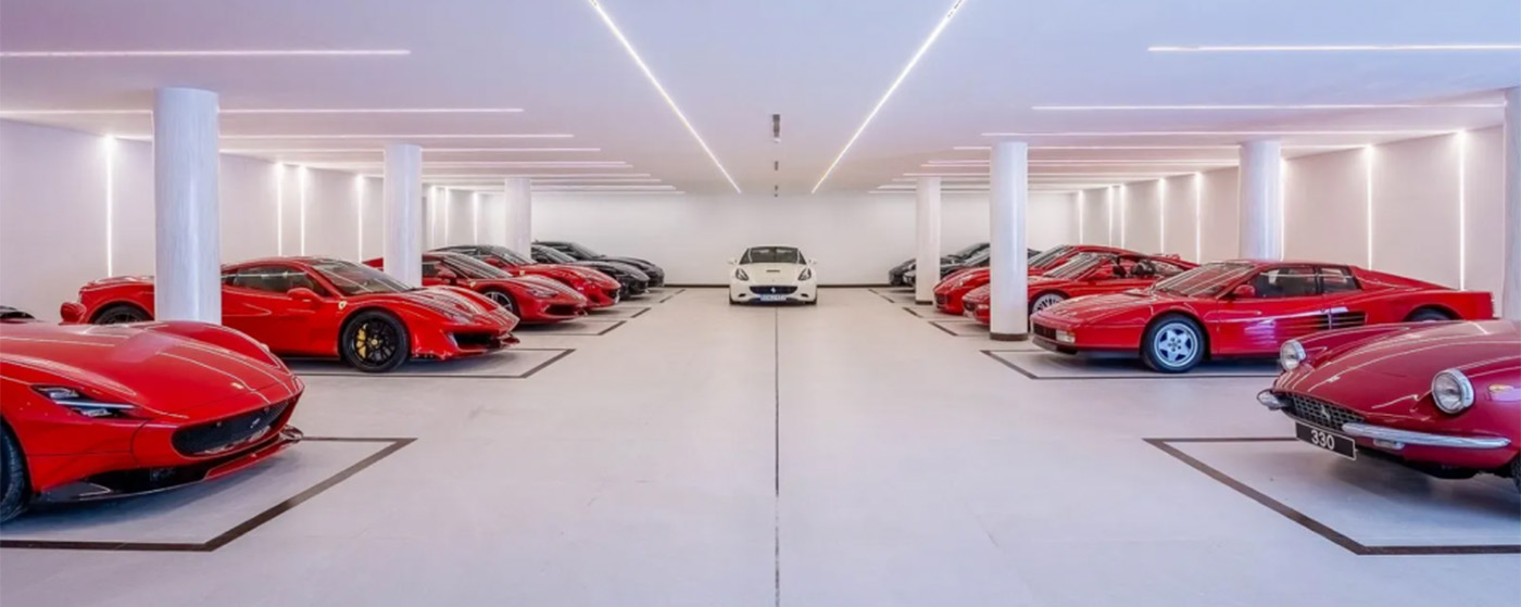 Massive white garage with 9 cars in it with plenty of room to add more