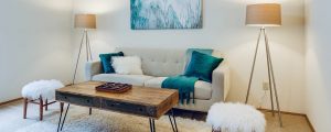 Living room with gray couch, white and green pillows and throw